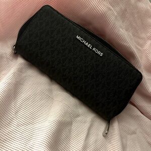 Black MK wallet with silver details.